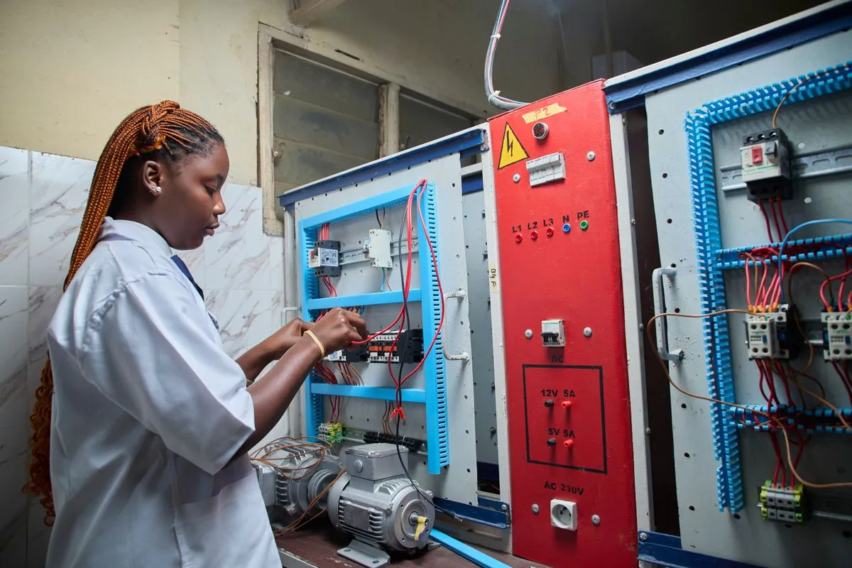 Technician wiring an industrial electrical control panel